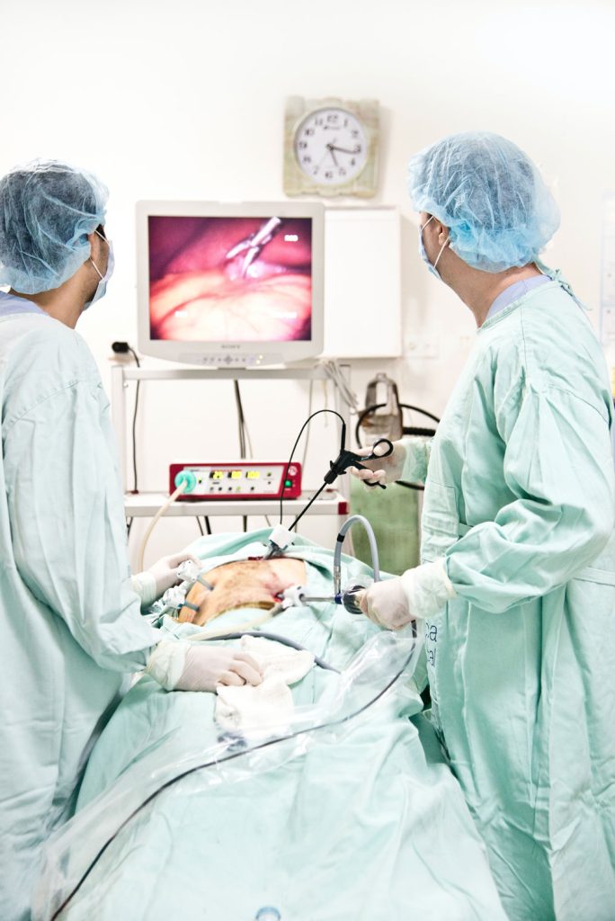doctors performing colonoscopy on a patient
