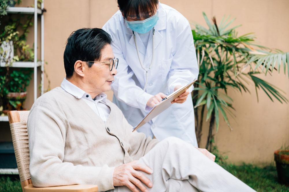 elderly patient speaking with a healthcare worker