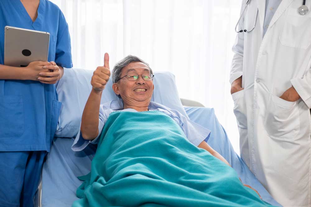 old male patient giving a thumbs up