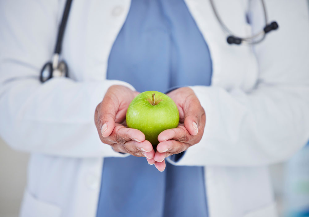 doctor holding an apple with both hands